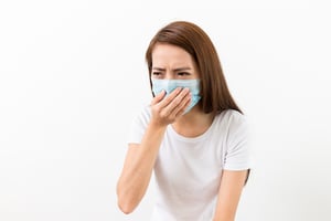 Asian woman sneeze with mask