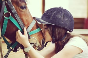 Happy young people on countryside with horse for riding