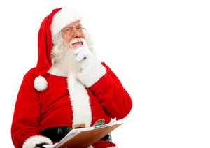 Santa thinking on the christmas list isolated on white